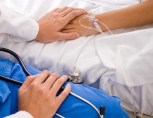 doctor-comforting-patient-in-bed